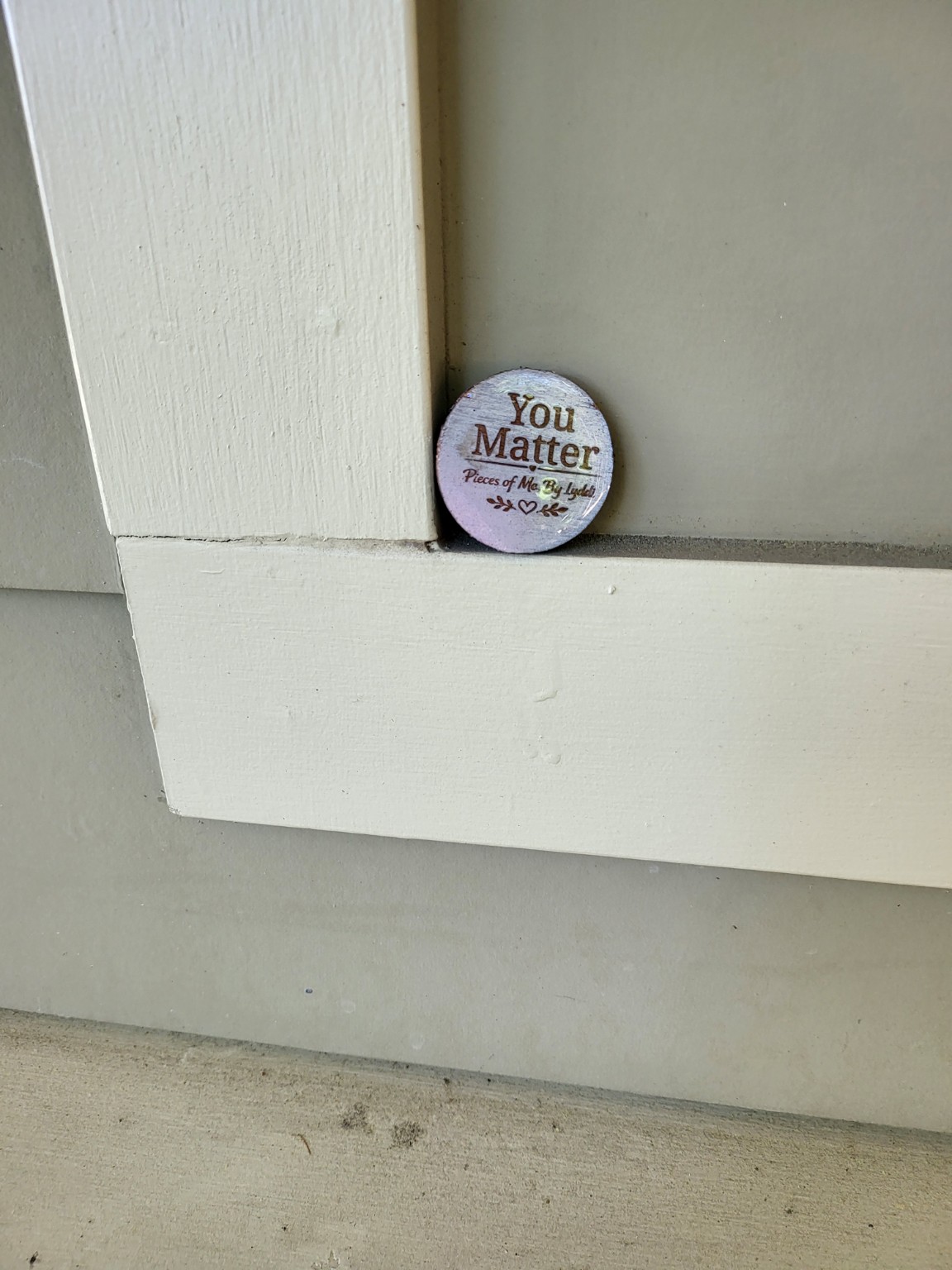 A heartwork token placed on the ledge of a public building