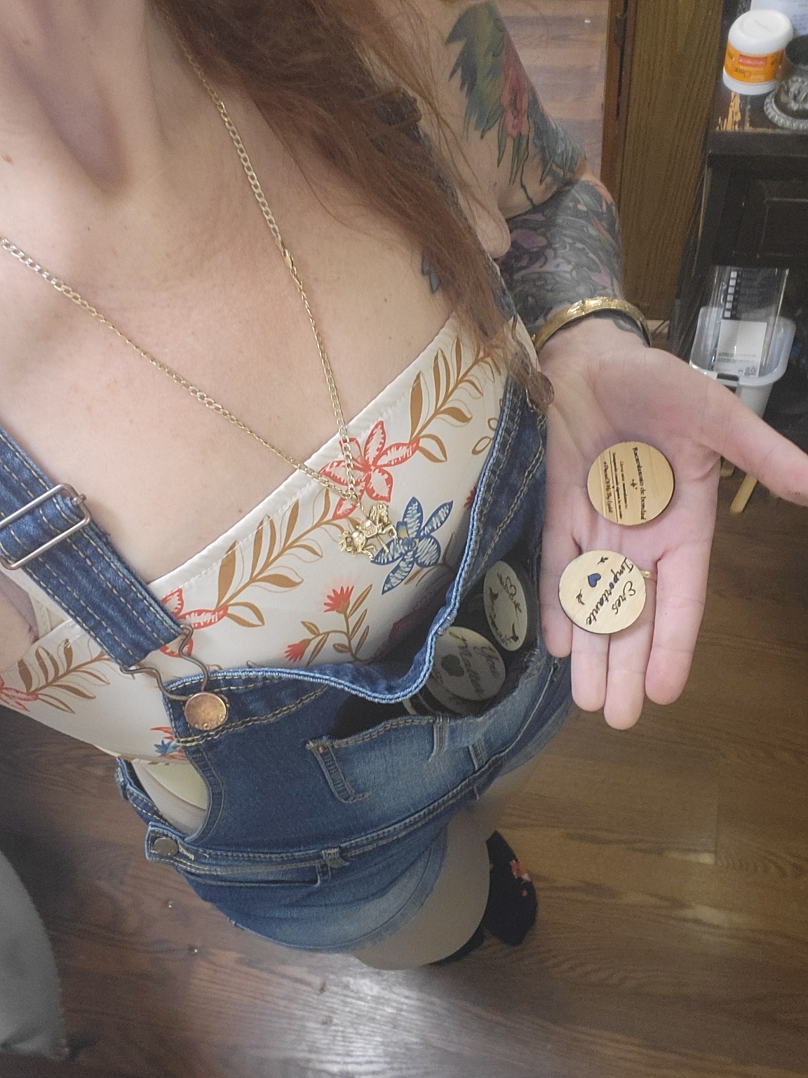 Lyddi holding a collection of handmade heartwork tokens