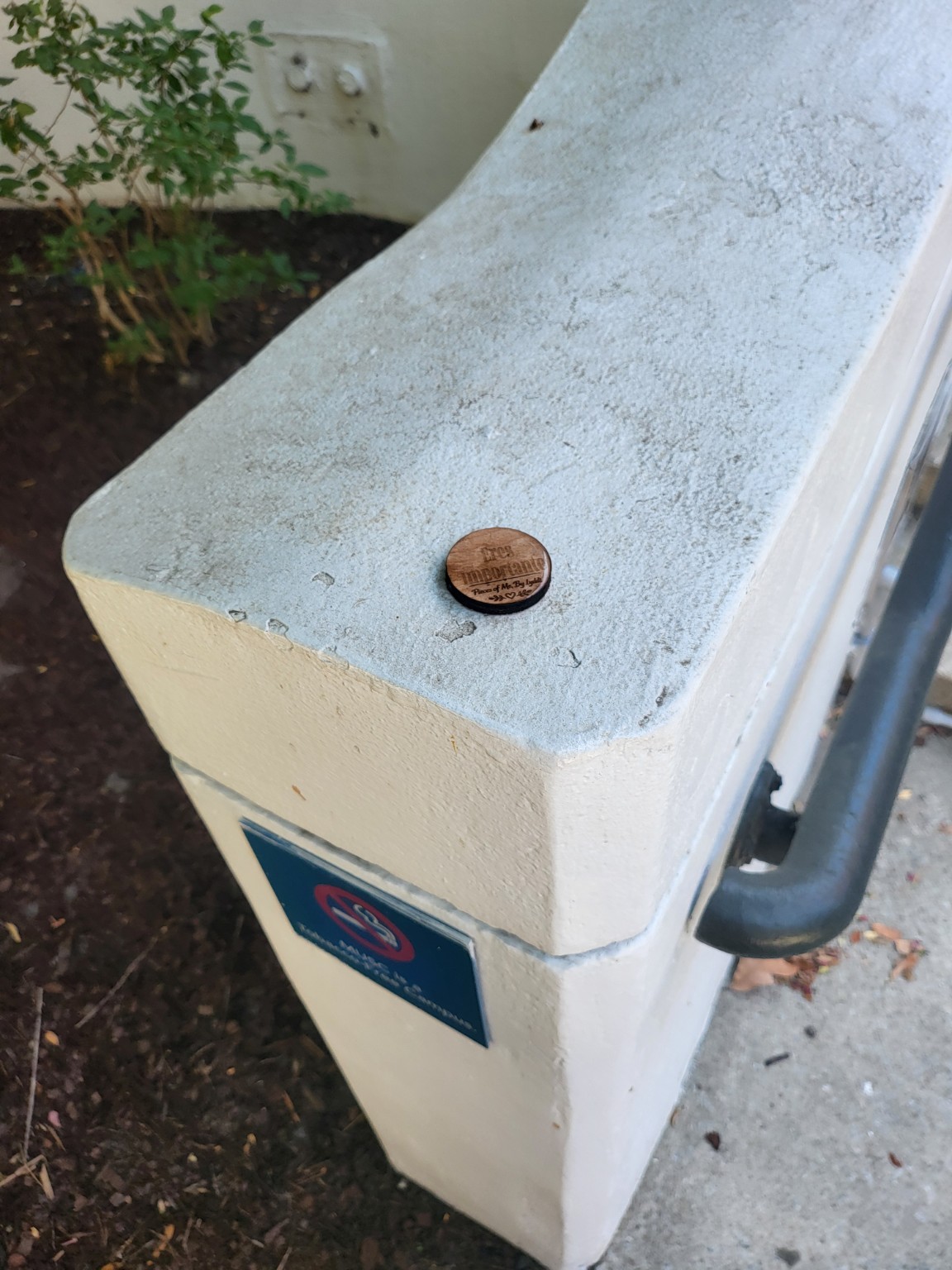 A heartwork token placed on a white public utility box