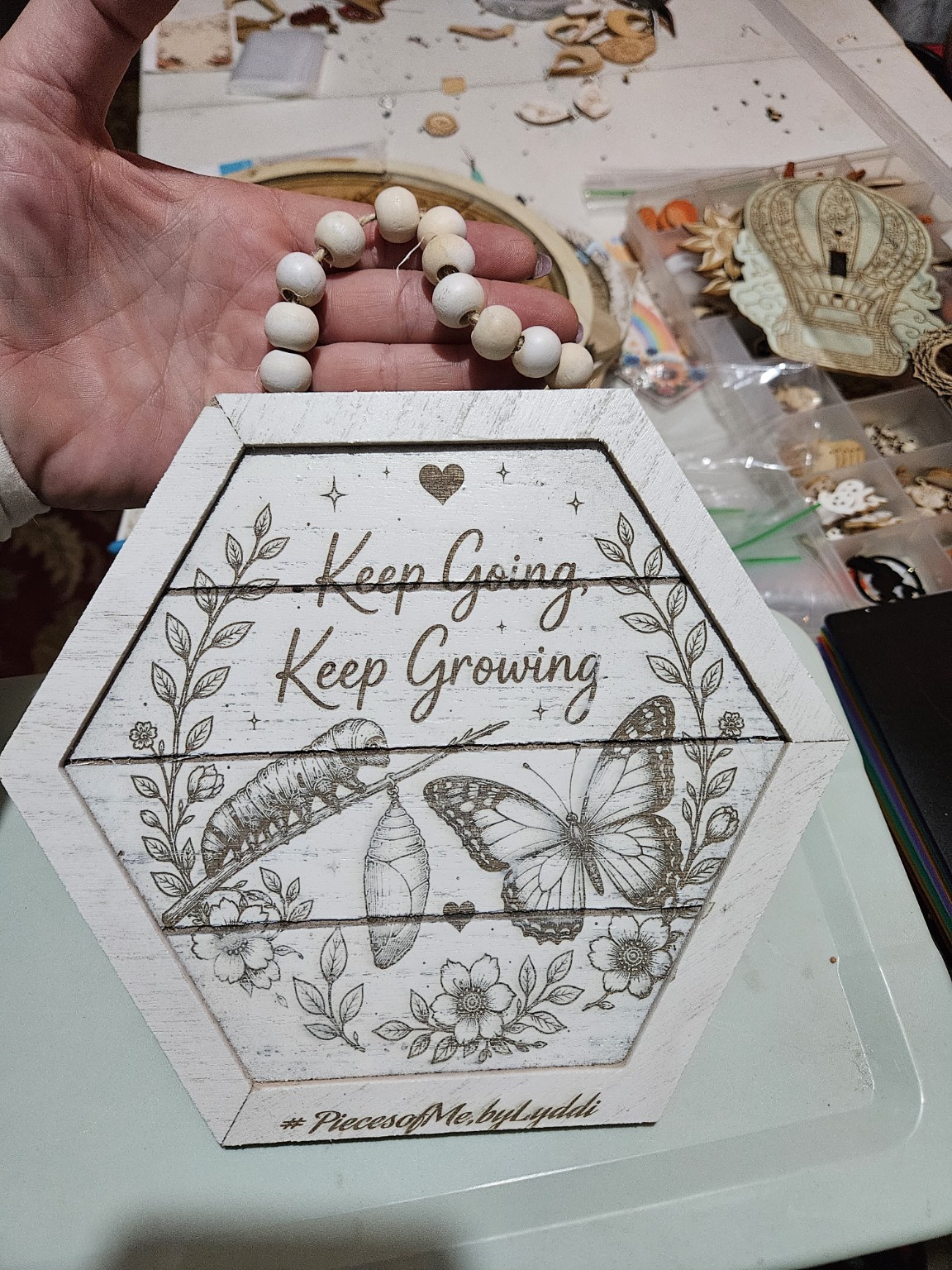 Handmade hexagon wooden sign reading Keep Going Keep Growing, with flowers, leafy vines, a caterpillar, chrysalis, and butterfly
